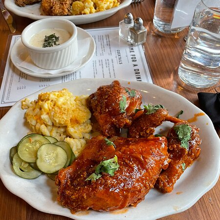 Tupelo Honey Southern Kitchen & Bar signature dishes Honey Dusted Fried Chicken, Shrimp and Grits, Famous Fried Green Tomatoes, Biscuits for a Cause.